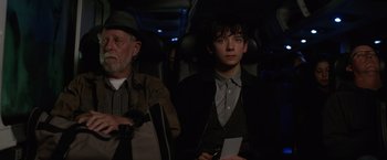 Movie still from “The Space Between Us” (2017), directed by Peter Chelsom – A young man and an older man sitting on a bus; Medium shot, Over the shoulder angle