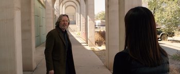 Movie still from “The Space Between Us” (2017), directed by Peter Chelsom – An older man and a young woman are walking down a sidewalk; Medium shot, Over the shoulder angle