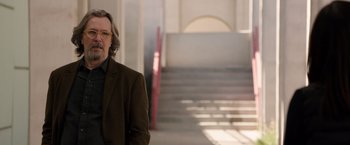 Movie still from “The Space Between Us” (2017), directed by Peter Chelsom – A man standing in front of a set of stairs; Medium shot, Over the shoulder angle