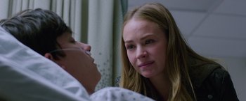 Movie still from “The Space Between Us” (2017), directed by Peter Chelsom – A young woman looking at a man in a hospital bed; Close Up shot, Over the shoulder angle