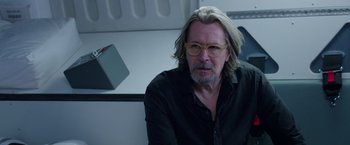 Movie still from “The Space Between Us” (2017), directed by Peter Chelsom – A man with long gray hair wearing glasses; Close Up shot, Over the shoulder angle