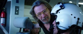 Movie still from “The Space Between Us” (2017), directed by Peter Chelsom – A man with long grey hair and glasses looking at the camera; Close Up shot, Over the shoulder angle