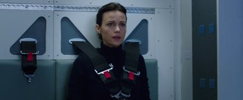 Movie still from “The Space Between Us” (2017), directed by Peter Chelsom – A woman sitting in a chair wearing a seat belt; Medium shot, Over the shoulder angle