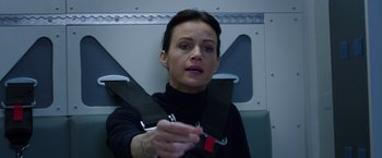 Movie still from “The Space Between Us” (2017), directed by Peter Chelsom – A woman holding a seat belt while sitting on a plane; Close Up shot, Low angle