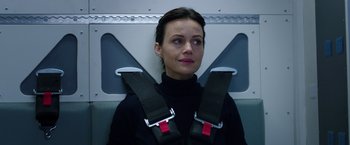 Movie still from “The Space Between Us” (2017), directed by Peter Chelsom – A woman sitting in a seat with a seat belt around her neck; Close Up shot, Low angle