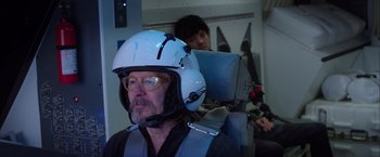 Movie still from “The Space Between Us” (2017), directed by Peter Chelsom – An older man wearing a helmet while sitting in an airplane seat; Close Up shot, Over the shoulder angle