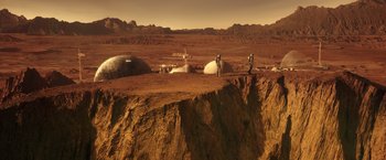 Movie still from “The Space Between Us” (2017), directed by Peter Chelsom – Two people standing on a cliff on a desert; Extreme Wide shot, High angle