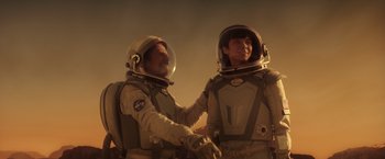 Movie still from “The Space Between Us” (2017), directed by Peter Chelsom – Two men in spacesuits are shaking hands; Medium shot, Over the shoulder angle