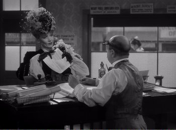 Movie still from “The Spoilers” (1942), directed by Ray Enright – A man and a woman at the counter of a restaurant; Medium shot, Over the shoulder angle