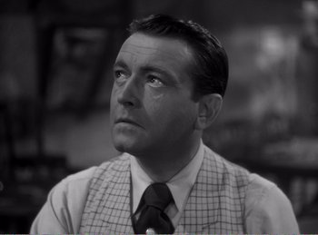 Movie still from “The Spoilers” (1942), directed by Ray Enright – An older man wearing a suit and tie looking to his left; Close Up shot, High angle