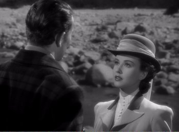 Movie still from “The Spoilers” (1942), directed by Ray Enright – A man and a woman talking in a rocky area; Close Up shot, Over the shoulder angle