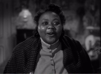 Movie still from “The Spoilers” (1942), directed by Ray Enright – An old black and white photo of a woman; Close Up shot, Low angle