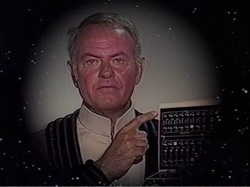 Movie still from “The Star Wars Holiday Special” (1978), directed by Steve Binder – An older man is pointing to the side of his face; Close Up shot, High angle