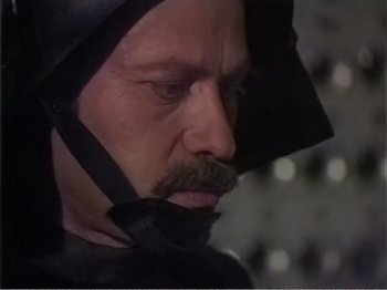 Movie still from “The Star Wars Holiday Special” (1978), directed by Steve Binder – A person wearing a hood; Close Up shot, High angle