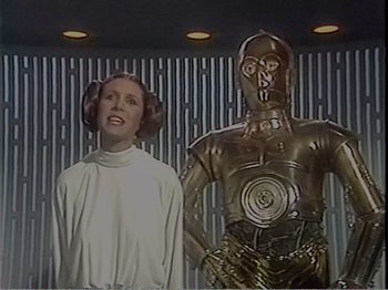 Movie still from “The Star Wars Holiday Special” (1978), directed by Steve Binder – A woman and a man in star wars costumes; Medium shot, Low angle