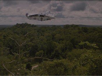 Movie still from “The Star Wars Holiday Special” (1978), directed by Steve Binder – An airplane is flying over a lush green forest; Extreme Wide shot, Low angle