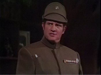 Movie still from “The Star Wars Holiday Special” (1978), directed by Steve Binder – A man in a military uniform wearing a hat; Close Up shot, Over the shoulder angle