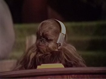 Movie still from “The Star Wars Holiday Special” (1978), directed by Steve Binder – A wookiee listening to music with headphones on; Close Up shot, High angle