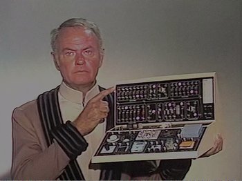 Movie still from “The Star Wars Holiday Special” (1978), directed by Steve Binder – An older man holding a computer case in front of his face; Extreme Close Up shot, Overhead angle