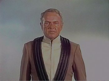 Movie still from “The Star Wars Holiday Special” (1978), directed by Steve Binder – An older man wearing a suit and tie; Medium shot, Low angle