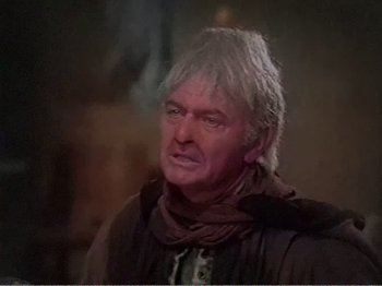 Movie still from “The Star Wars Holiday Special” (1978), directed by Steve Binder – An older man with white hair is looking at the camera; Close Up shot, Over the shoulder angle