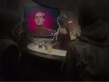 Movie still from “The Star Wars Holiday Special” (1978), directed by Steve Binder – A woman sitting at a table in front of a painting; Medium shot, Over the shoulder angle
