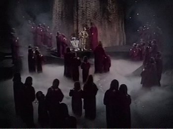 Movie still from “The Star Wars Holiday Special” (1978), directed by Steve Binder – A group of people standing around a stage; Extreme Wide shot, High angle