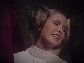 Movie still from “The Star Wars Holiday Special” (1978), directed by Steve Binder – A young woman with long brown hair wearing a princess leia costume; Close Up shot, Over the shoulder angle