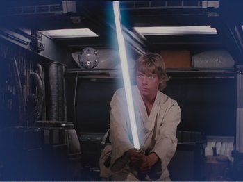 Movie still from “The Star Wars Holiday Special” (1978), directed by Steve Binder – A young man holding a light saber in a room; Medium shot, Low angle