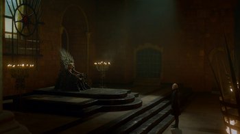 Movie still from “Game of Thrones” (2011), created by D.B. Weiss – A man standing in front of a statue of the iron throne; Extreme Wide shot, High angle