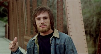 Movie still from “The Stunt Man” (1980), directed by Richard Rush – A person with a beard wearing a jean jacket; Close Up shot, Low angle