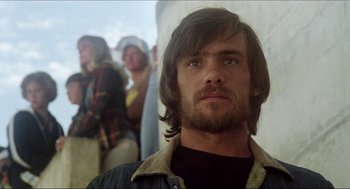 Movie still from “The Stunt Man” (1980), directed by Richard Rush – A person with long hair and a beard; Close Up shot, Low angle