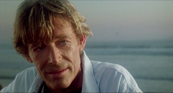 Movie still from “The Stunt Man” (1980), directed by Richard Rush – A person wearing a white shirt; Close Up shot, Low angle
