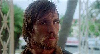 Movie still from “The Stunt Man” (1980), directed by Richard Rush – A person with long hair and a beard; Close Up shot, Over the shoulder angle