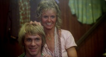 Movie still from “The Stunt Man” (1980), directed by Richard Rush – A man and a woman pose for a picture; Close Up shot, Low angle