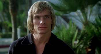 Movie still from “The Stunt Man” (1980), directed by Richard Rush – A person with long blonde hair; Close Up shot, Low angle