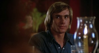 Movie still from “The Stunt Man” (1980), directed by Richard Rush – A person sitting at a table; Close Up shot, Low angle