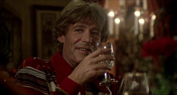 Movie still from “The Stunt Man” (1980), directed by Richard Rush – A man holding a wine glass in his hand; Close Up shot, Over the shoulder angle