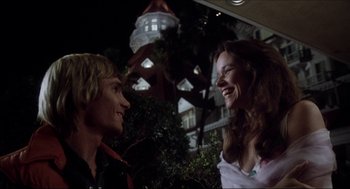 Movie still from “The Stunt Man” (1980), directed by Richard Rush – A man and a woman talking to each other outside; Medium shot, Low angle