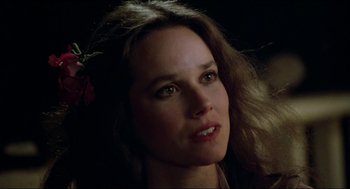 Movie still from “The Stunt Man” (1980), directed by Richard Rush – A person with a flower in her hair; Close Up shot, Over the shoulder angle