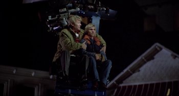 Movie still from “The Stunt Man” (1980), directed by Richard Rush – Two men sitting in a ferris wheel at night; Wide shot, Low angle