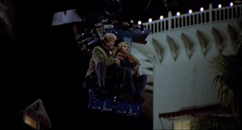 Movie still from “The Stunt Man” (1980), directed by Richard Rush – Two people sitting on a chair in the middle of the night; Wide shot, Low angle