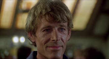 Movie still from “The Stunt Man” (1980), directed by Richard Rush – A person wearing a blue shirt; Close Up shot, Low angle