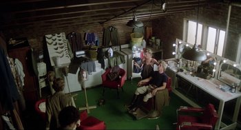 Movie still from “The Stunt Man” (1980), directed by Richard Rush – A group of people sitting around in a room; Wide shot, High angle