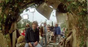 Movie still from “The Stunt Man” (1980), directed by Richard Rush – A group of people standing around a tree; Wide shot, Over the shoulder angle