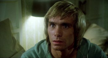 Movie still from “The Stunt Man” (1980), directed by Richard Rush – A person with long blonde hair; Close Up shot, Low angle