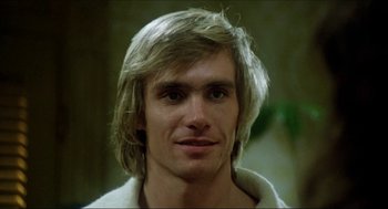 Movie still from “The Stunt Man” (1980), directed by Richard Rush – A person with long blonde hair; Close Up shot, Low angle