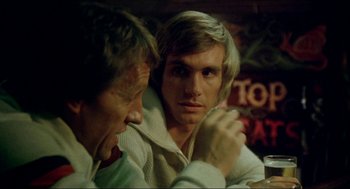 Movie still from “The Stunt Man” (1980), directed by Richard Rush – Two men sitting at a table in front of each other; Close Up shot, Over the shoulder angle