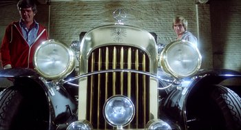 Movie still from “The Stunt Man” (1980), directed by Richard Rush – The front of an antique car; Wide shot, Low angle