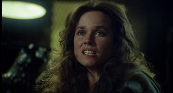 Movie still from “The Stunt Man” (1980), directed by Richard Rush – A person with long curly hair; Close Up shot, Over the shoulder angle